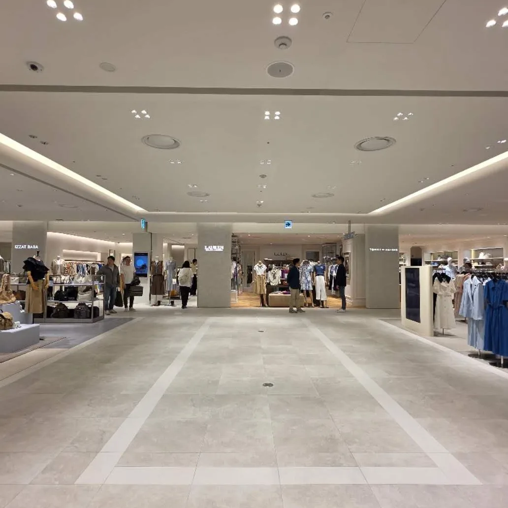 Luxury retail interior illuminated with track spotlights and architectural lighting