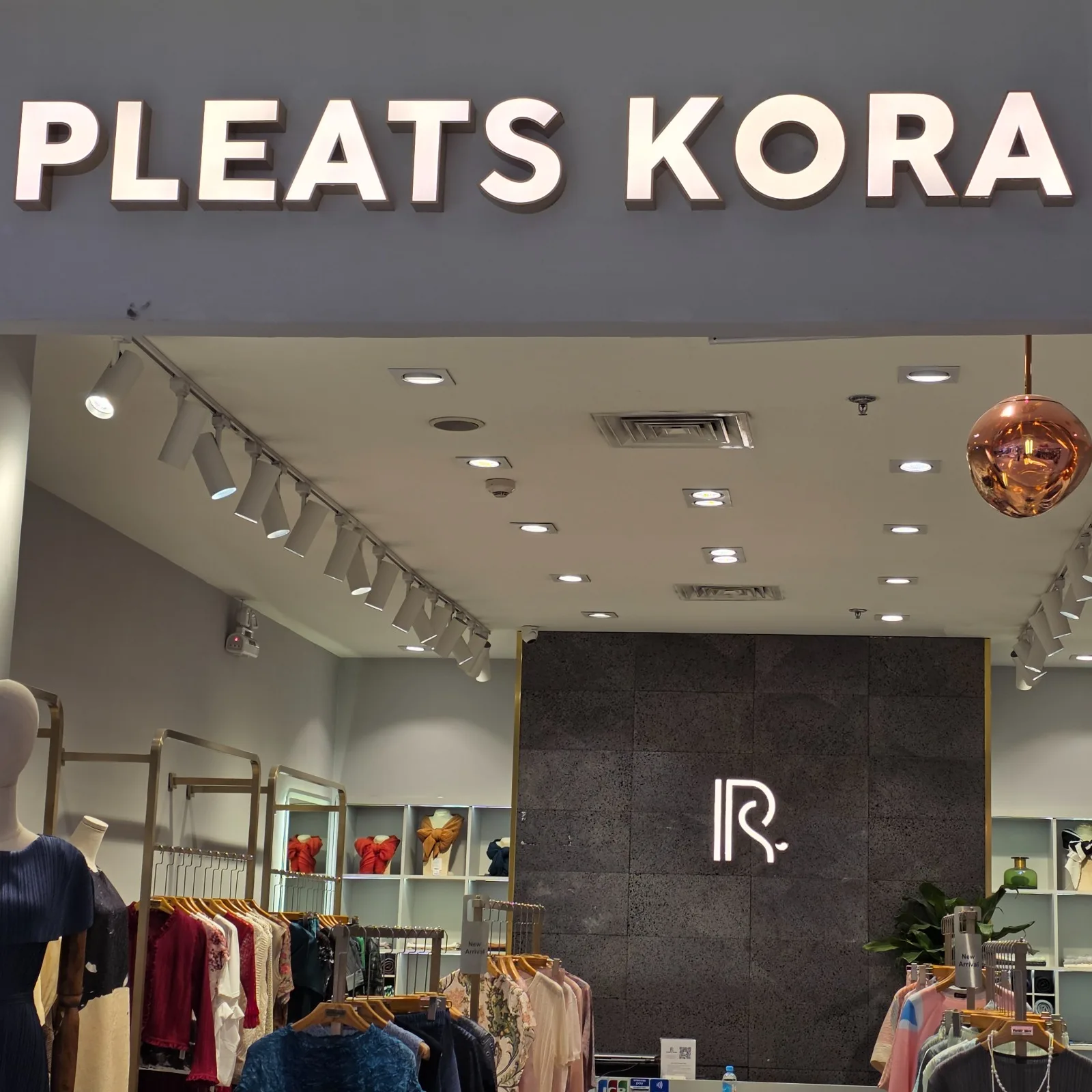 Track lights installed in the PLEATS KORA retail store, providing premium accent lighting for fashion displays and boutique interiors.