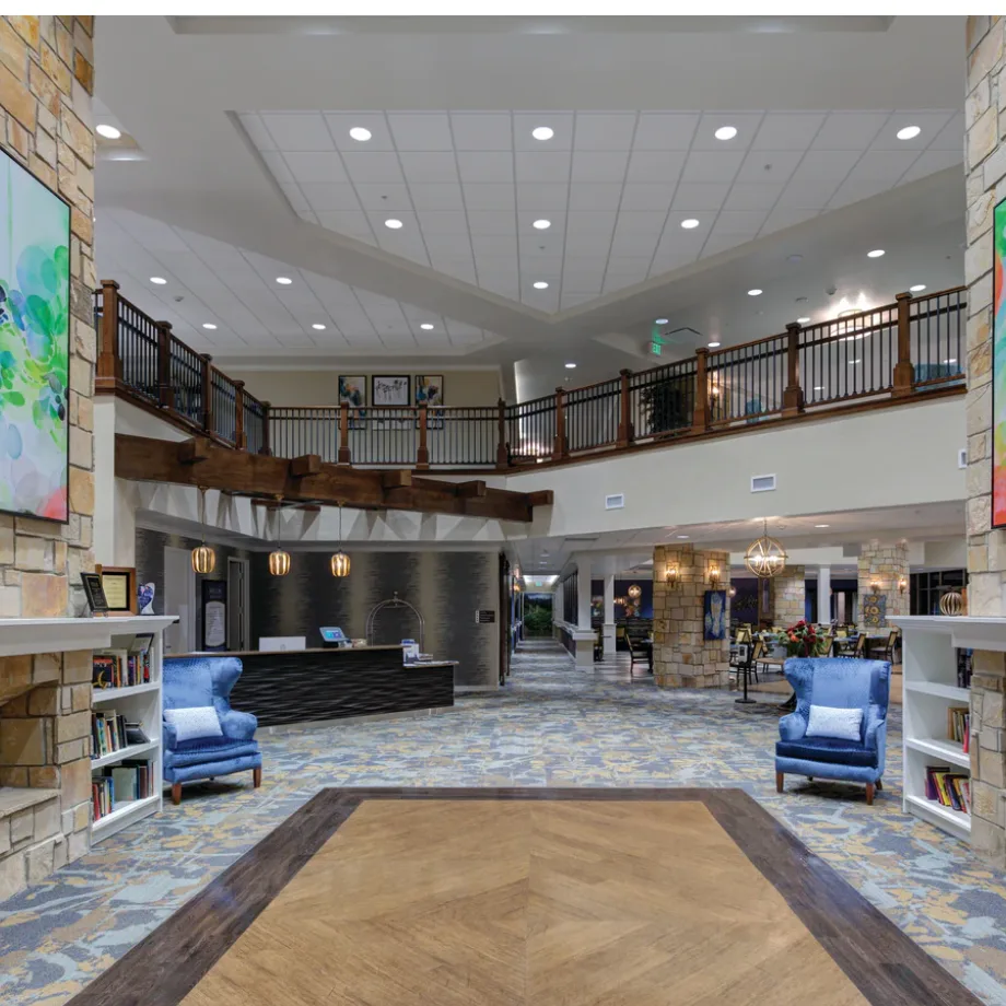 Commercial office arrival lobby with downlights guiding the entrance and circulation route