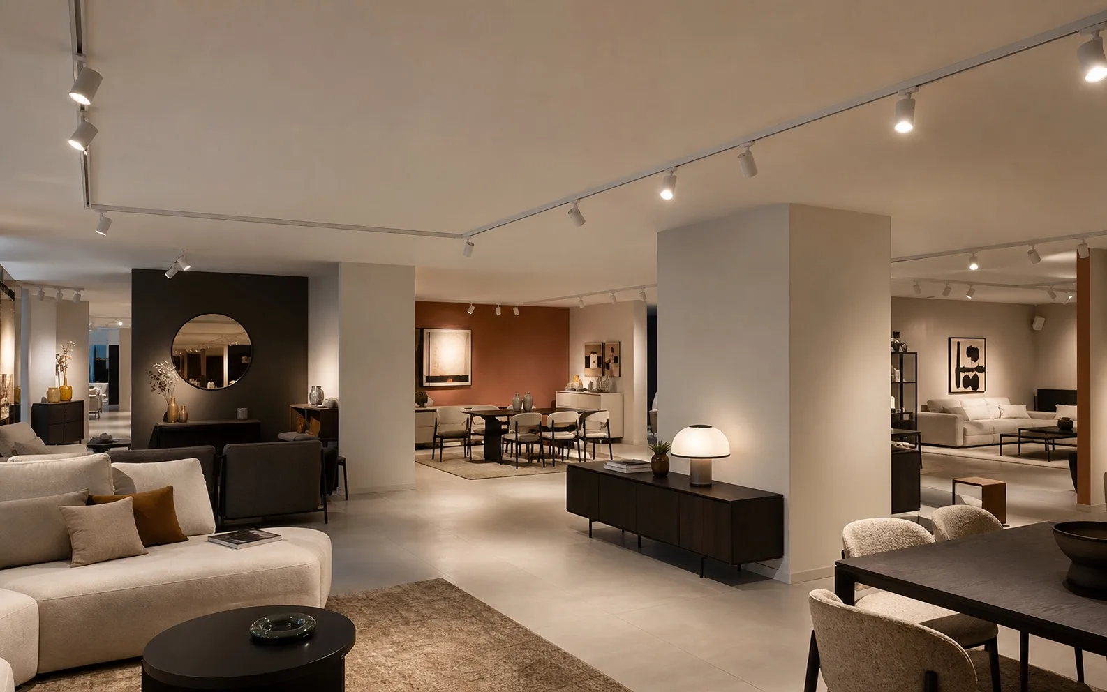 White surface-mounted one-circuit track with L connectors lighting a contemporary furniture showroom