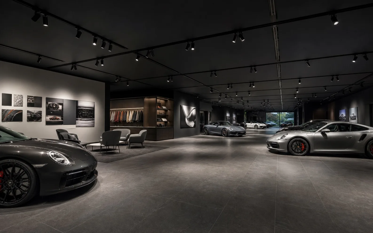 Black three-circuit four-wire track grid lighting vehicles lounge and graphics in an automotive experience centre
